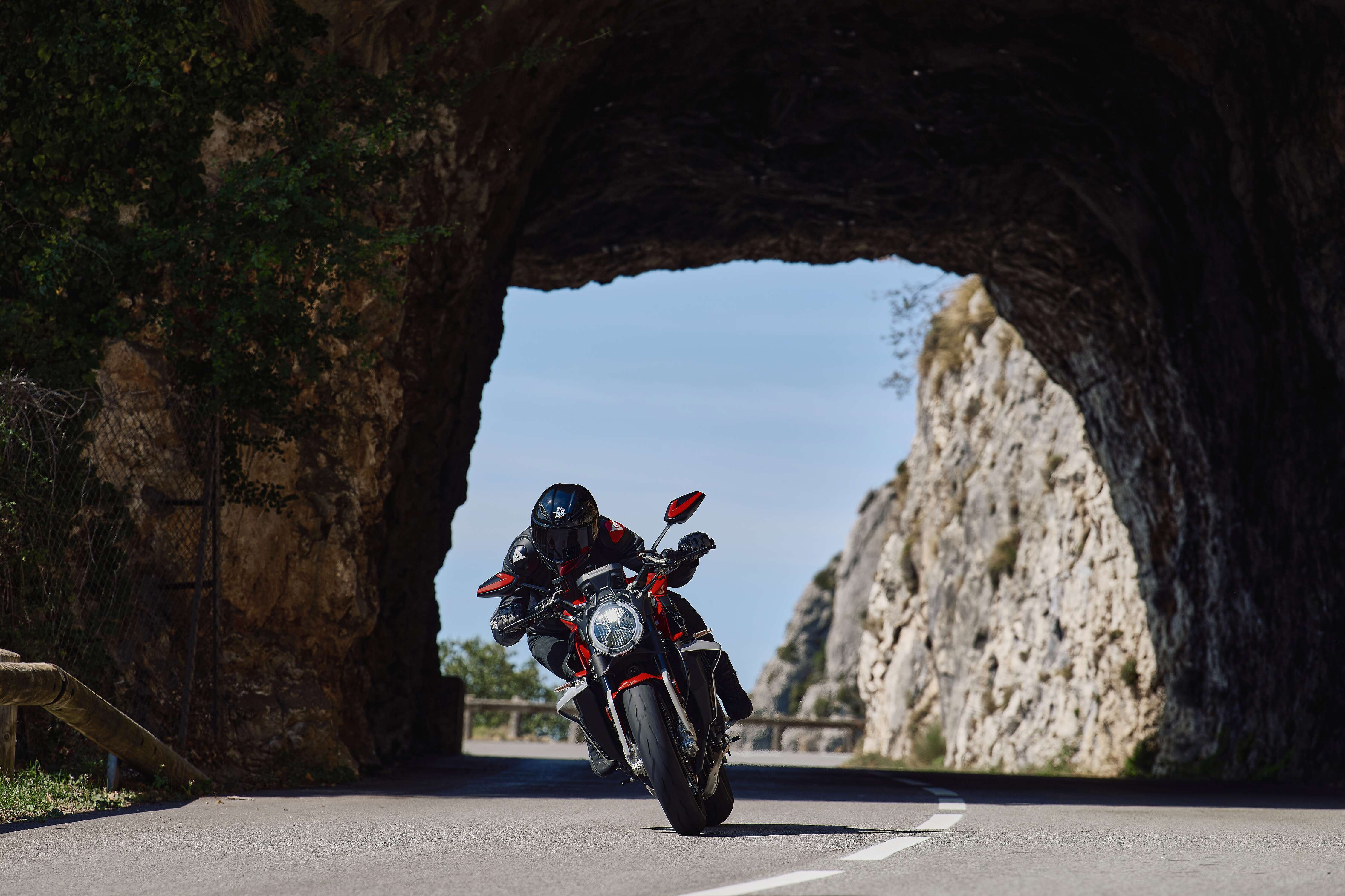 MV Agusta Brutale 1000 Ottantesimo leaning through a mountain road tunnel, showcasing premium naked bike performance and precision handling.