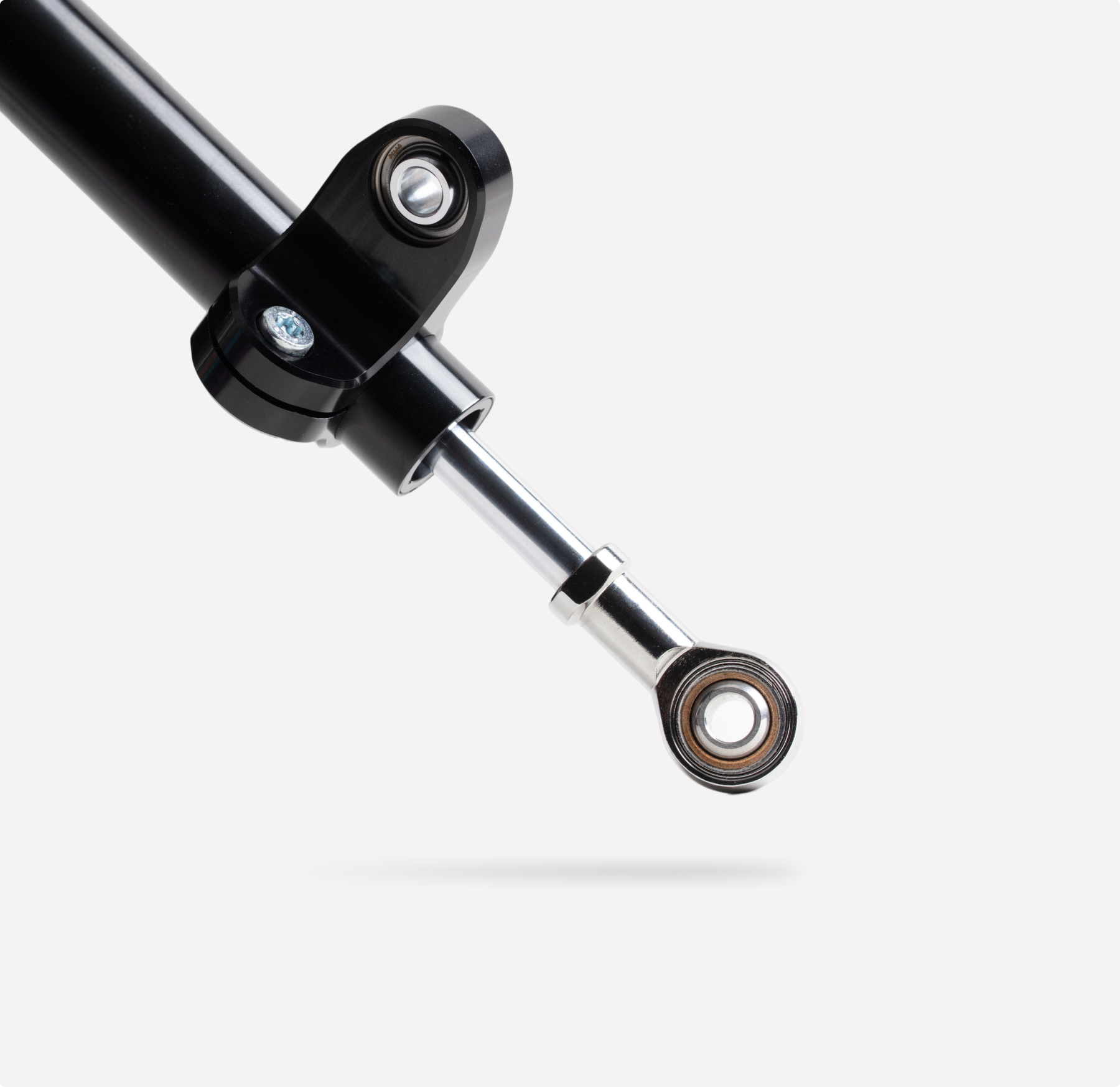 Marzocchi motorcycle steering damper with black anodized body and chrome piston rod.