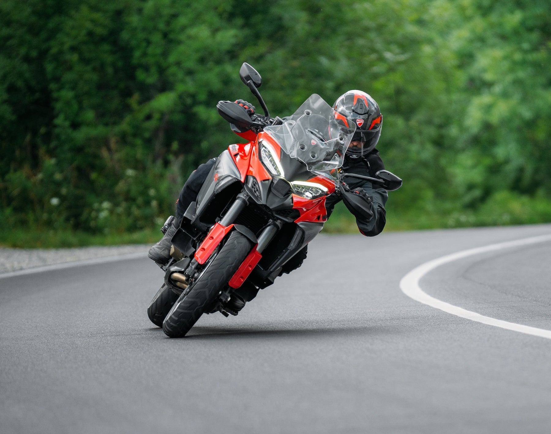 Marzocchi-equipped Ducati Multistrada V4 RS in a high-speed cornering action shot.