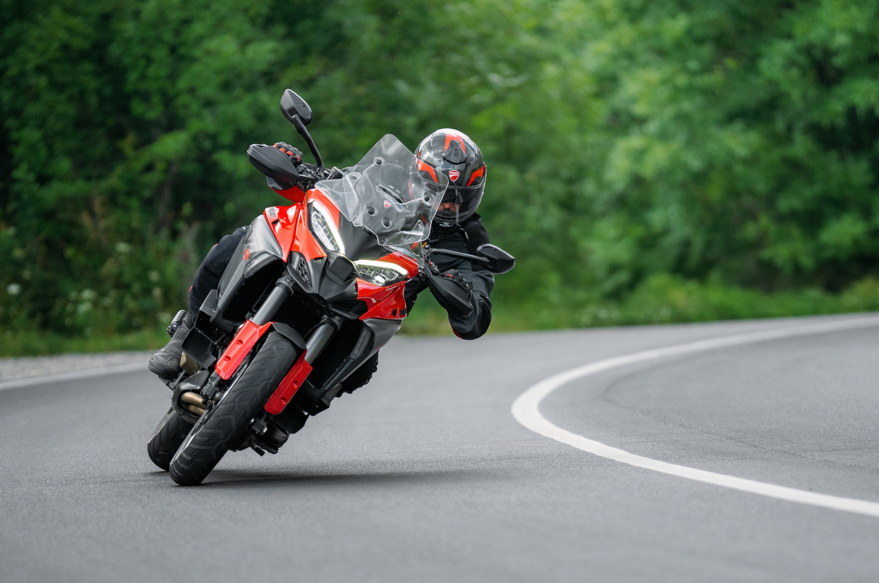 Marzocchi-equipped Ducati Multistrada V4 RS in a high-speed cornering action shot.