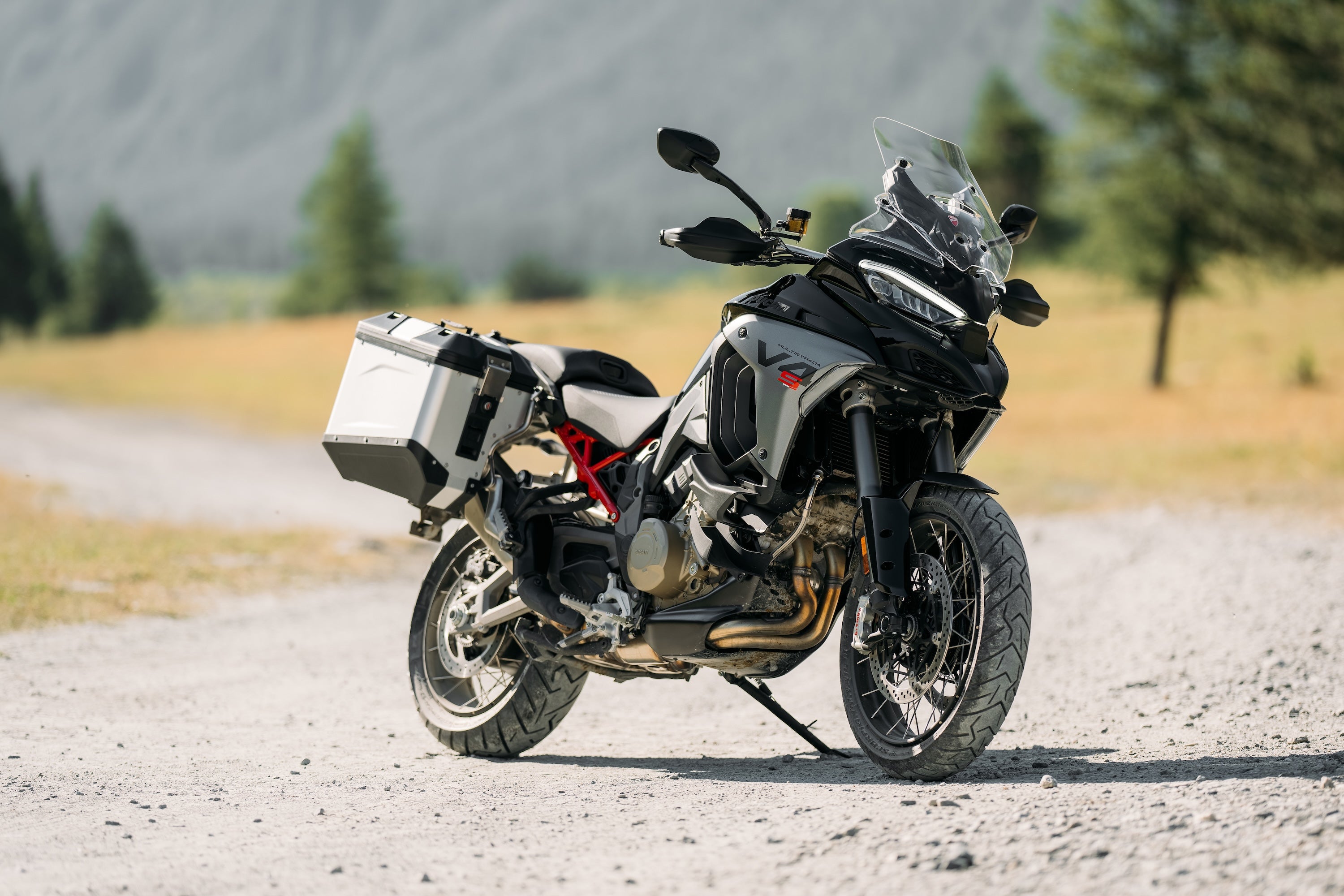 Ducati Multistrada V4 S adventure motorcycle on a gravel path with Marzocchi touring suspension.