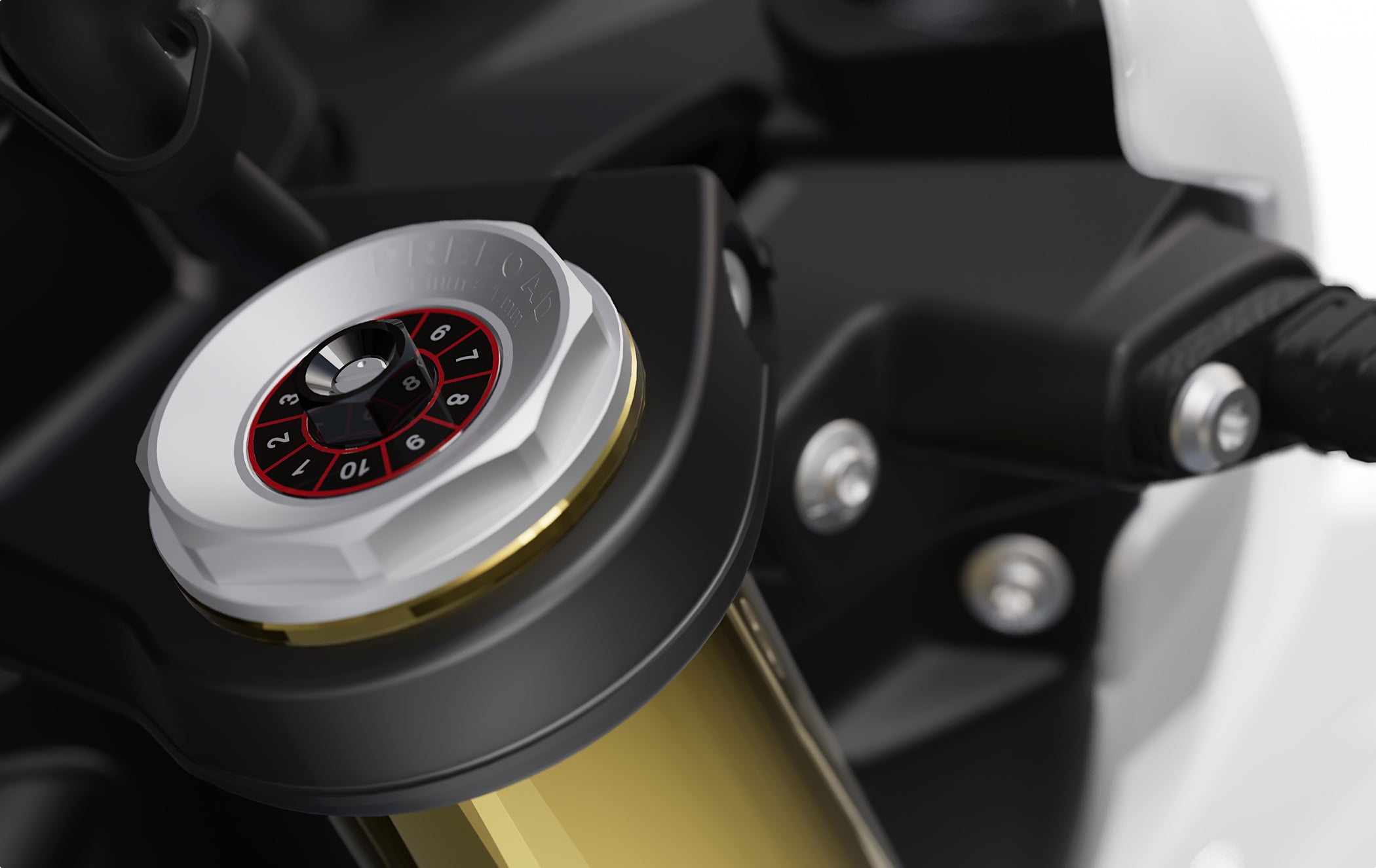 Close-up of motorcycle front fork preload adjustment dial with numbered settings.