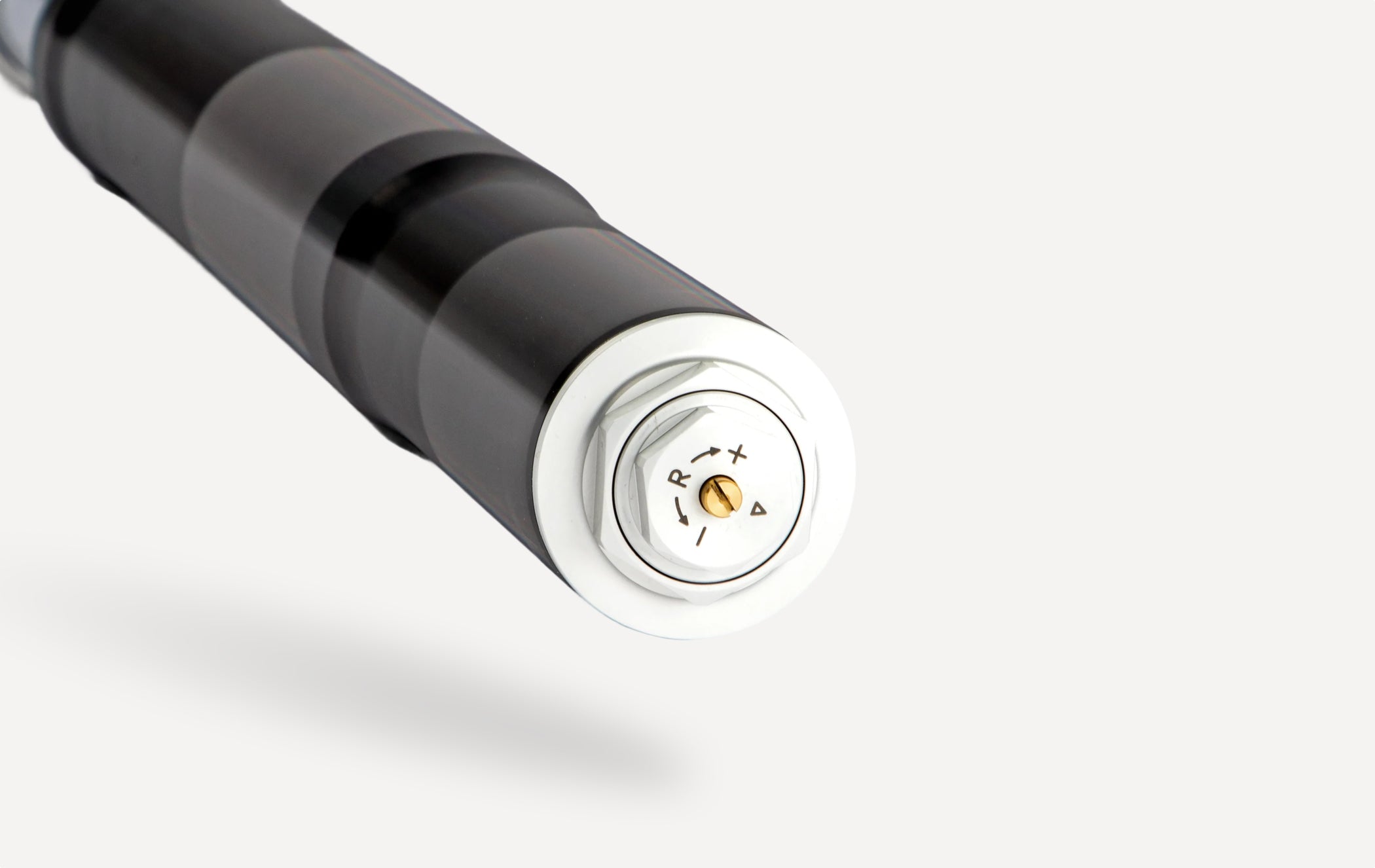 Close-up of motorcycle fork rebound adjuster on performance suspension component.