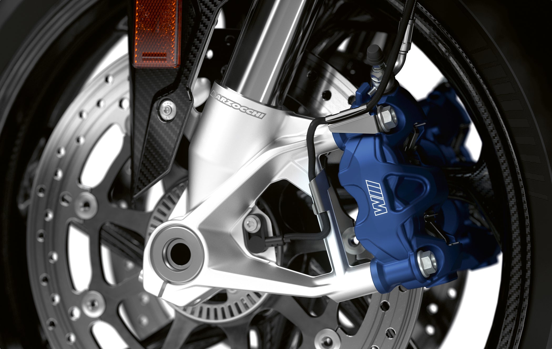 Close-up of Marzocchi motorcycle front fork and brake caliper assembly, showcasing precision-engineered suspension and braking components.