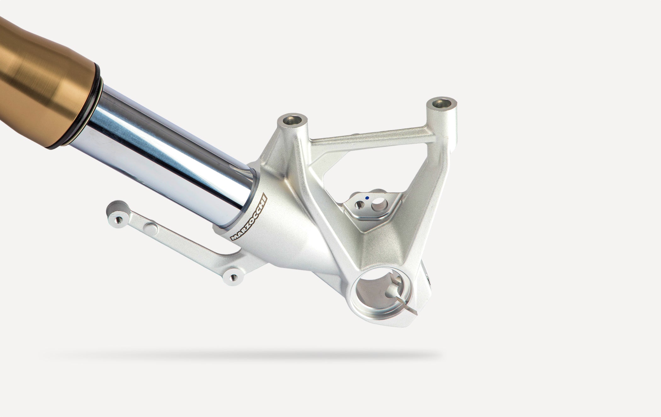 Marzocchi motorcycle front fork lower assembly with gold stanchion tube, showcasing precision-engineered suspension component.