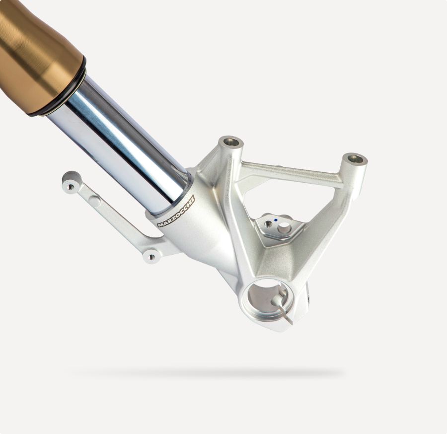 Marzocchi motorcycle front fork lower assembly with gold stanchion and aluminum fork bottom.