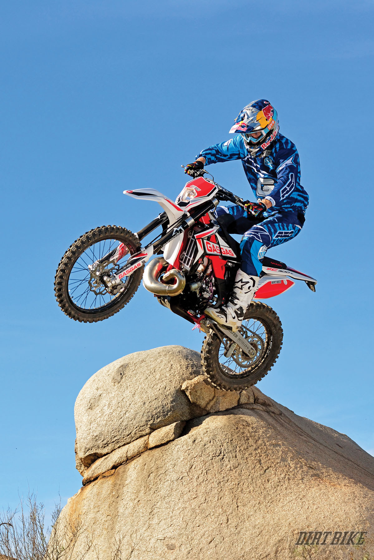 GASGAS XC 300 dirt bike with Marzocchi forks performing an extreme enduro rock pivot.