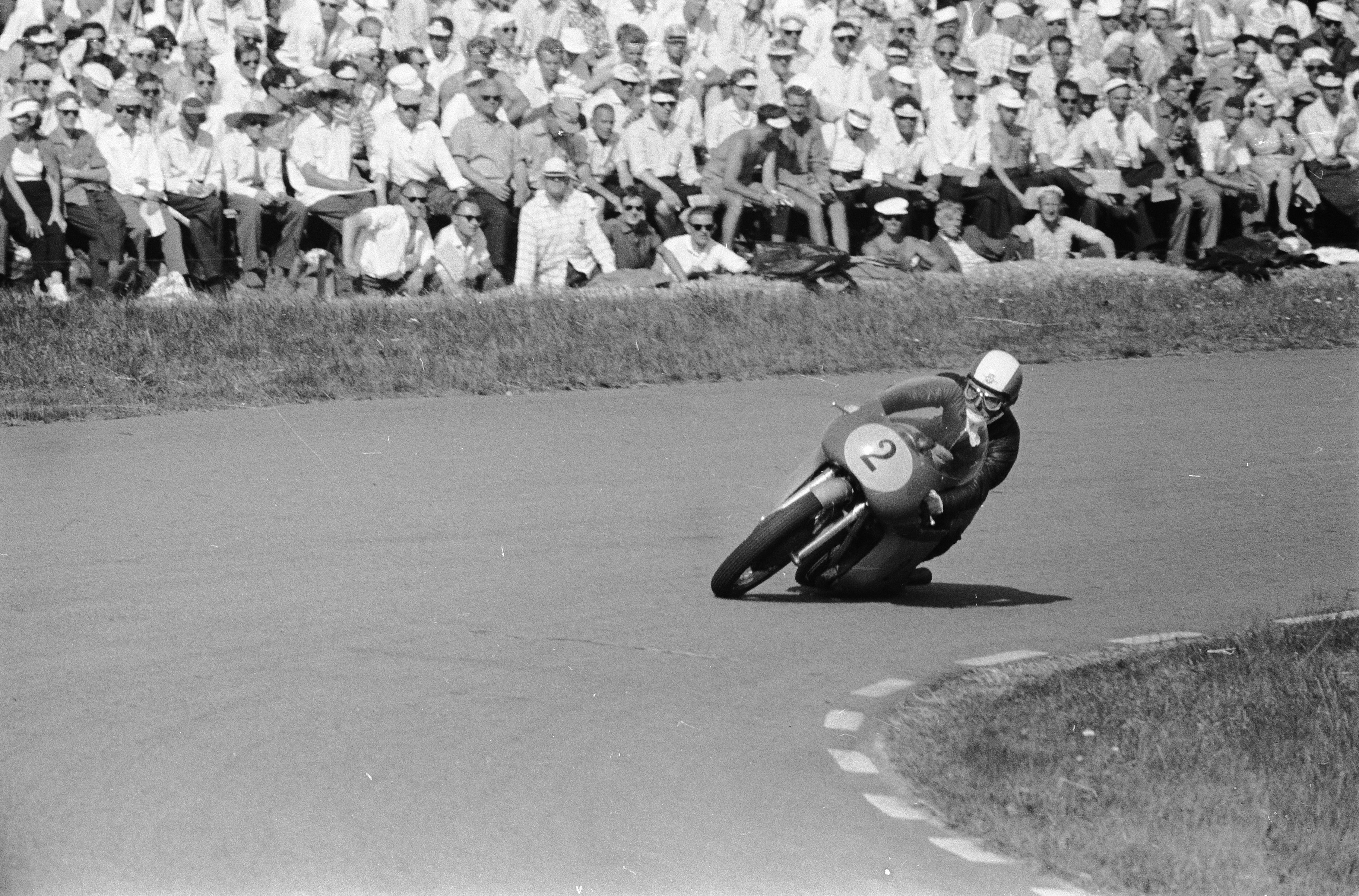 Vintage racing photo of Tarquinio Provini on the #2 Moto Morini 250 Bialbero at the 1963 Dutch TT, featuring early Marzocchi racing suspension.
